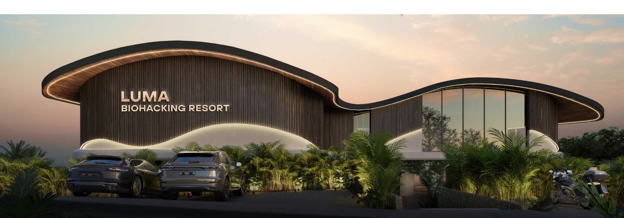 Luma Biohacking Resort at dusk, curved timber façade lit from below, Uluwatu jungle in the foreground.