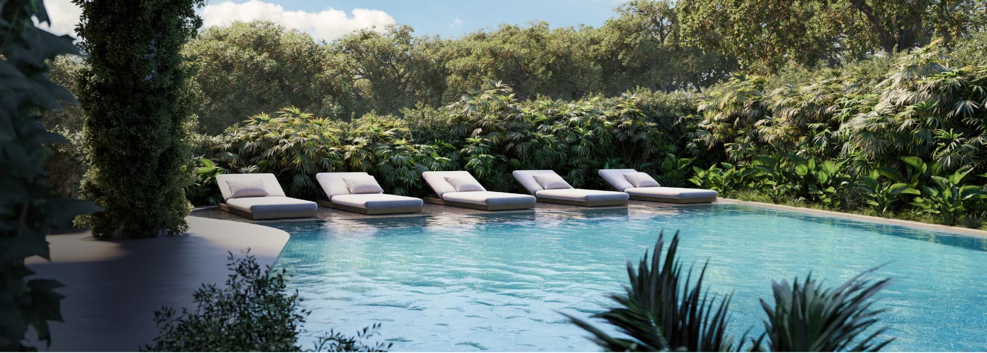 Panoramic infirmity pool bordered by loungers and tropical planting.