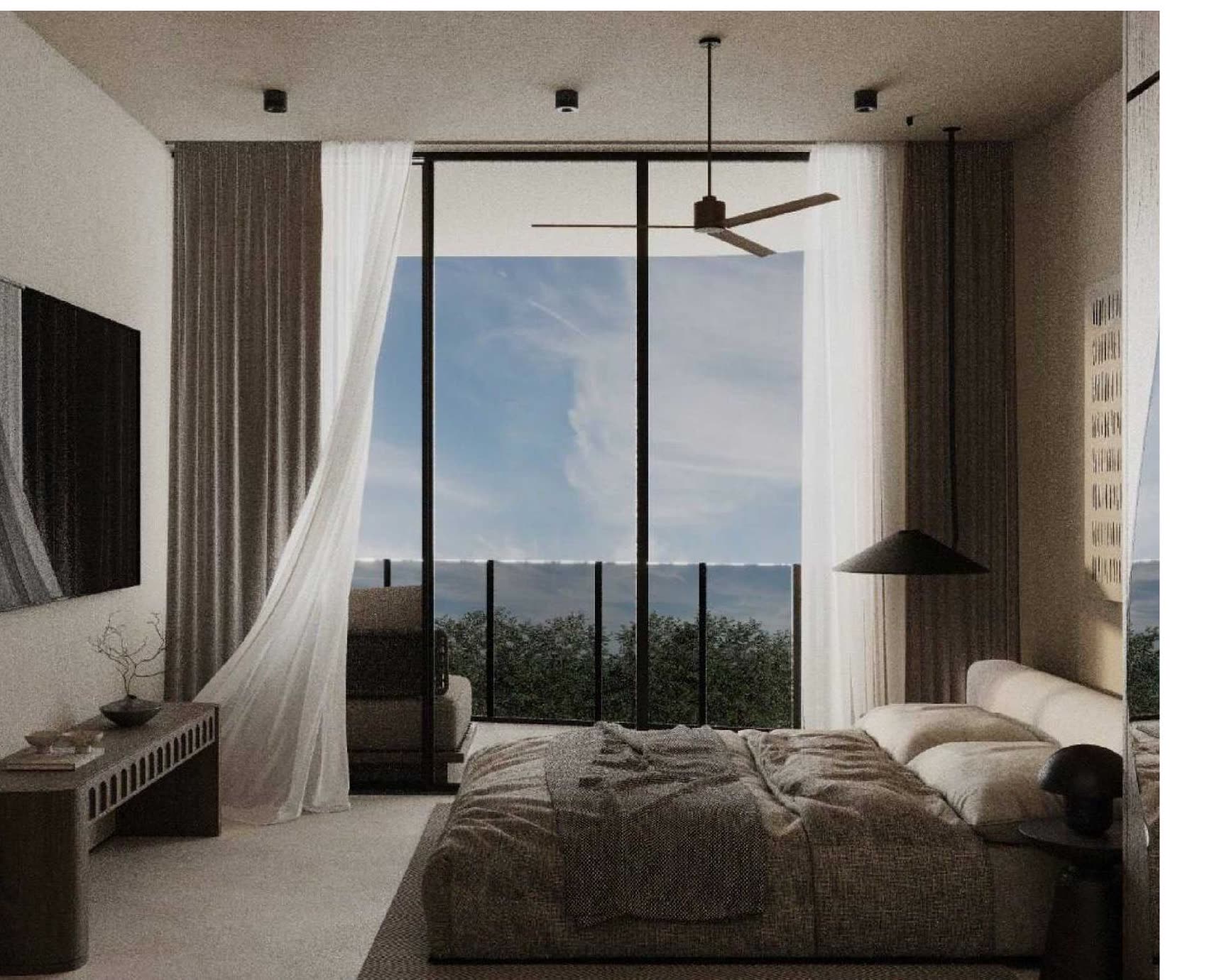 Studio residence bedroom with sea-facing glass doors and sheer curtains.